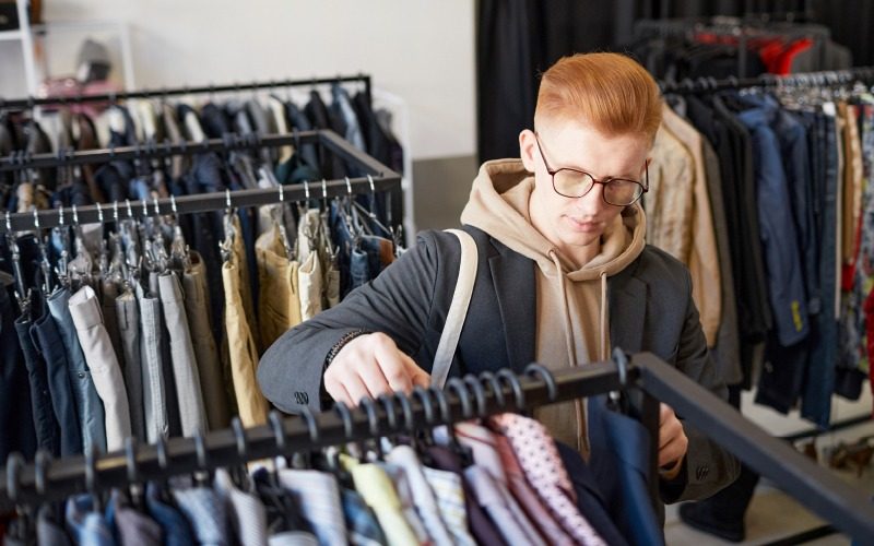 Corporate Social Responsibility – sustainable shopping, man at an op shop Corporate Social Responsibility - sustainable shopping, man at an op shop